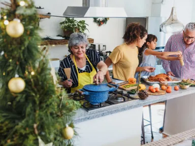 Latin family cooking together for Christmas dinner at home, conserve water at home while preparing turkey meat in holidays