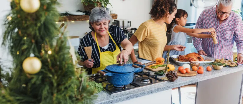 Latin family cooking together for Christmas dinner at home, conserve water at home while preparing turkey meat in holidays