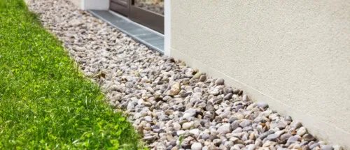 A gravel area in front of a home